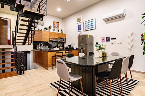 Open-concept kitchen and dining area, featuring modern appliances and sleek decor