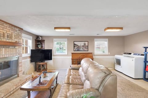 Family room with washer and dryer with 55 inch tv