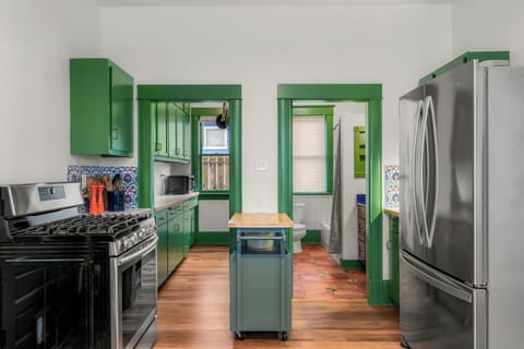 Spacious kitchen with center island equipped with cooking essentials.