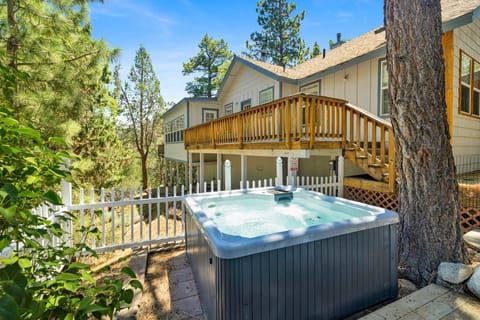 Private outdoor hot tub, surrounded by tall pines, perfect for relaxing under the trees after a day of adventure—enjoy peaceful forest views, fresh air, and a truly rejuvenating stay.