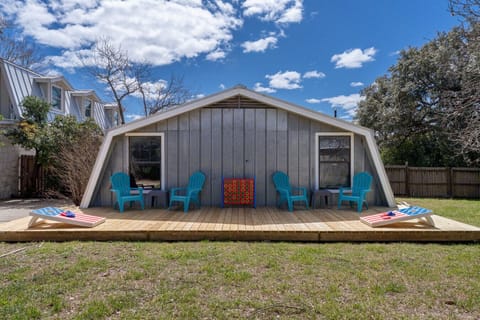 Backyard deck with lounge seating and games.