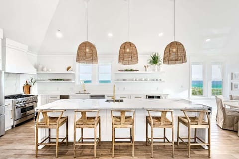 4. Spacious kitchen with a large island and seating, ideal for enjoying morning coffee or group meal prep.