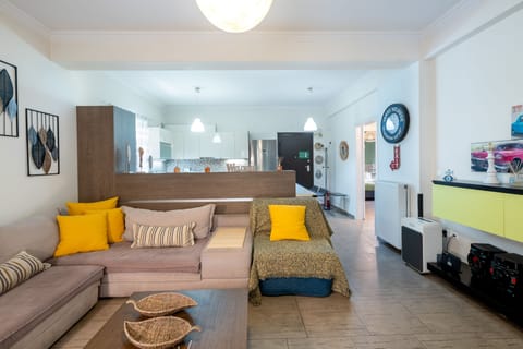 A spacious and comfortable living room with a huge couch and a smart TV.