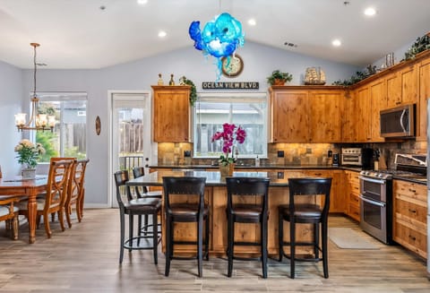 Inviting kitchen featuring rich wood cabinetry a spacious island with seating