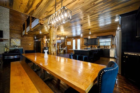 Savor meals in a rustic dining space with a polished wood table, modern lighting, and warm, natural wood finishes throughout.