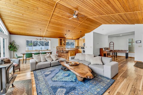 Living room: Wood-burning fireplace, Smart TV, foosball table, piano