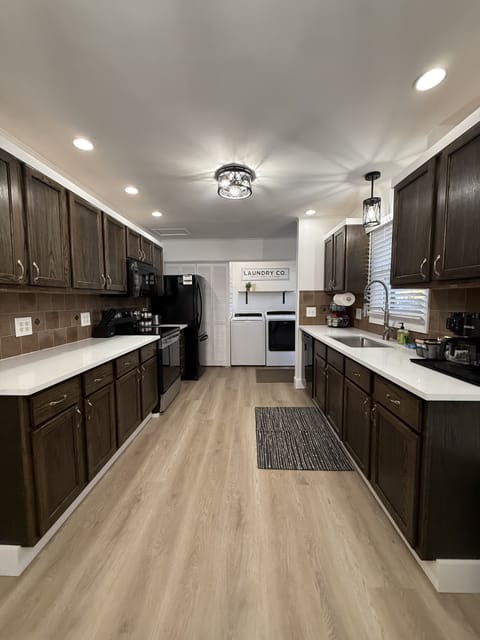 Beautiful fully stocked kitchen and laundry area.