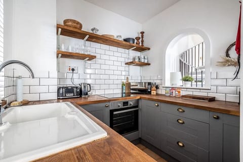Modern farmhouse style kitchen with all the typical utensils for preparing meals.
