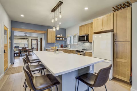 A chef’s dream kitchen – featuring modern appliances, light wood cabinetry, and a spacious island with pendant lighting. Perfect for preparing meals and gathering with friends and family..