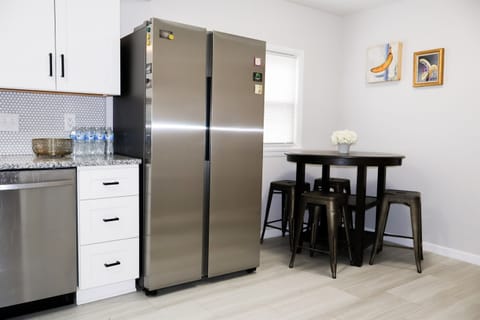 Kitchen with seating eating area and stainless fridge/freezer with ice machine inside