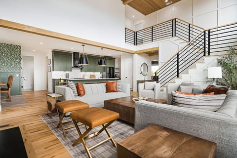 Step into luxury! This elegant living room seamlessly opens to a spacious outdoor deck, offering stunning views and fresh air. Perfect for indoor-outdoor living, relaxation, and entertaining in style.