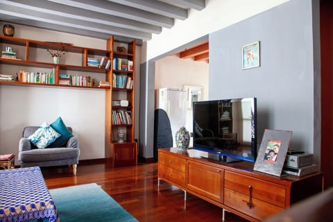 open plan living room leading to dining and kitchen; large freezer visible
