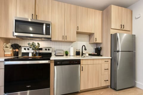 Modern kitchen with full-size stainless steel appliances—ideal for cooking meals during longer stays. 🍳