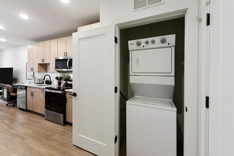 In-Unit laundry machine with Tide pods and Bounce dryer sheets.