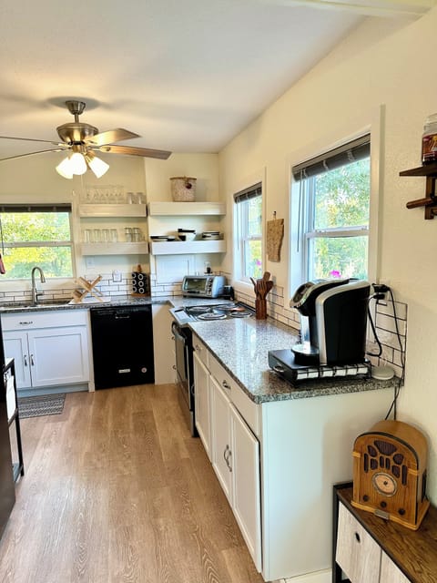 Kitchen with dishwasher, oven, Keurig, microwave, fridge, and toaster oven.