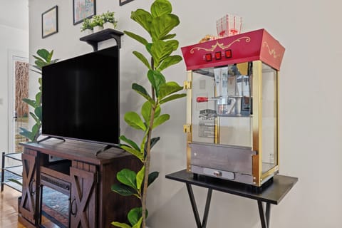 Living room smart TV and popcorn machine with popcorn and bags!