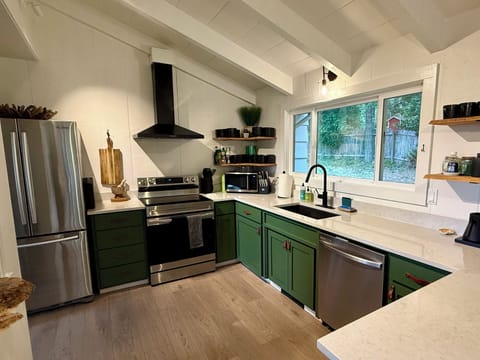 The fully equipped kitchen with a dishwasher is stocked with basic pantry items
