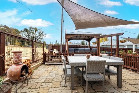 Gather around the chiminea to warm up and enjoy your meals at the outdoor dining table for a cozy, alfresco experience