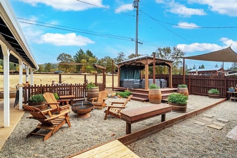 Relax and take in the stunning backyard views, with plenty of spots to unwind. Cozy up by the fire pit, lounge on the expansive wood deck, or enjoy a meal together under the sunshade on the paved patio.
