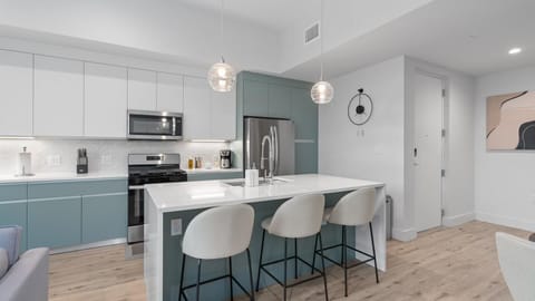 Contemporary kitchen with modern appliances and centered island with bar seating