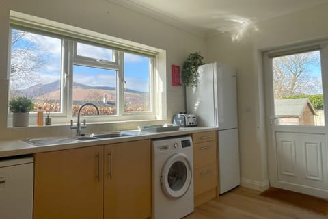 The kitchen includes a fridge, freezer, dishwasher and washer
