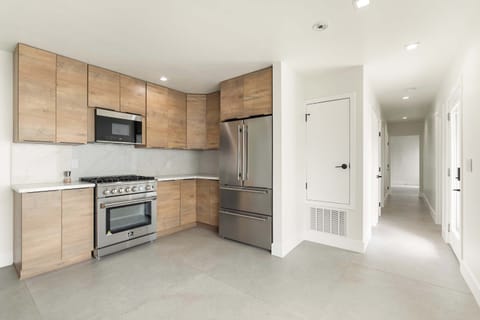 Modern, fully equipped kitchen! Prepare delicious meals in our stylish space with sleek cabinetry and stainless steel appliances. Enjoy the ample counter space and natural light. Perfect for cooking enthusiasts and those who love to entertain.