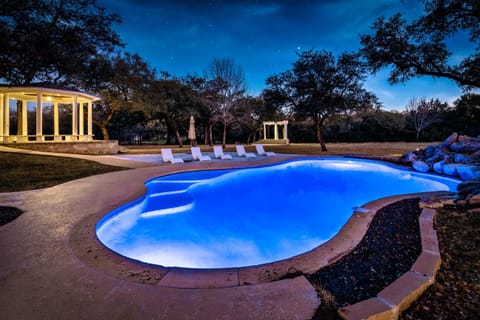 Swim under the stars in a glowing pool surrounded by peaceful nature and elegant gazebos!