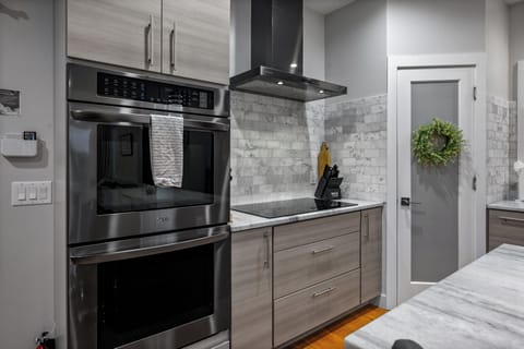 Cooking for the crowd with the double oven, while the dining room hums with family vibes.