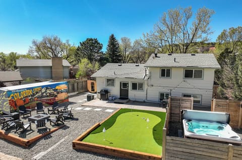 Welcome to Tonka Estate – your Colorado Springs retreat! Unwind in the stunning backyard oasis featuring a hot tub, putting green, BBQ, fire pit, and vibrant mural – perfect for relaxation and fun!
