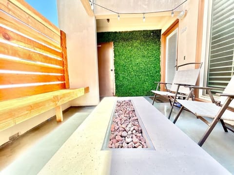 After a fun day at the beach, hang out and have a drink by the firepit