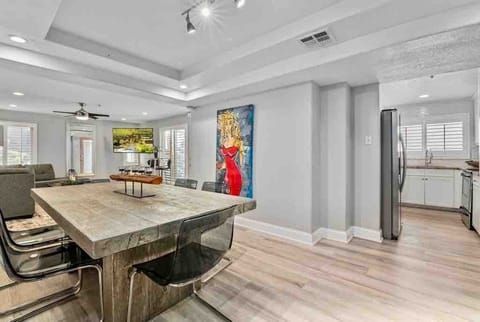 Kitchen next to dining with decorative paintings on the wall