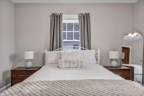 Queen hotel-quality bed with blackout curtains & USB charging nightstands