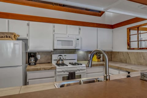 Kitchen: Second floor, drip coffee maker, blender, toaster, cooking utensils, tableware