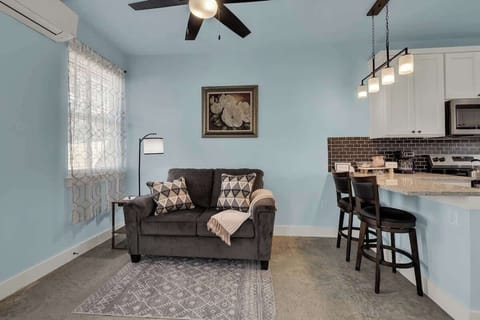 The cozy living room features a comfortable loveseat, creating an inviting spot to unwind after a day of exploring.