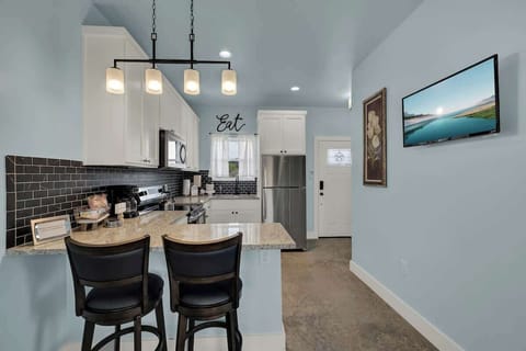 Enjoy casual meals or morning coffee at the cozy countertop dining space for two, perfect for relaxed vacation moments.