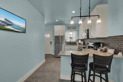 Enjoy casual meals or morning coffee at the cozy countertop dining space for two, perfect for relaxed vacation moments.