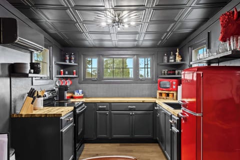 Kitchen: Unit 5 - Red accents and modern design make this kitchen a vibrant and inviting space. Perfect for cooking up a storm!