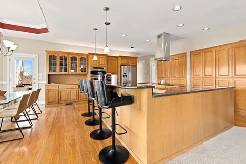 A dining table with four barstools nearby - ideal for gatherings and shared meals.