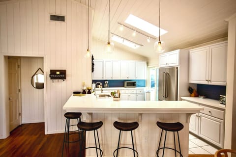 The spacious breakfast bar with seating for five invites casual dining, morning coffee, or late-night snacks.