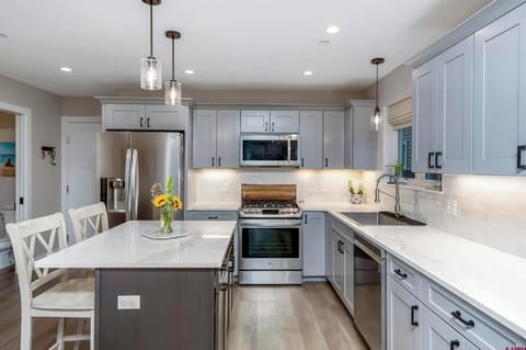 Kitchen with gas range and large farmhouse sink.