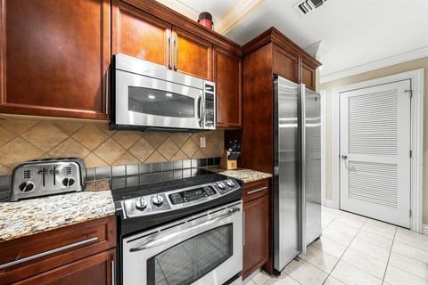 This fully equipped kitchen features a full-size refrigerator, an electric stove with oven, a microwave and toaster, along with a dishwasher for easy cleanup.