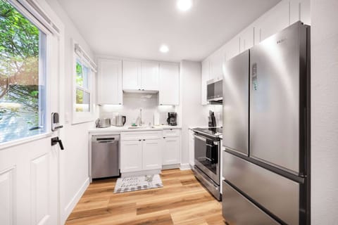 A modern, stylish kitchen with stainless steel appliances, gold accents, and all the essentials—perfect for cooking meals during your stay.