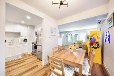 Bright and inviting dining space featuring sleek modern design and ample natural light, perfect for casual meals or special occasions. The open floor plan seamlessly connects this dining area to the rest of the living space.