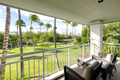 Peaceful tropical balcony retreat with lush palm tree garden views.