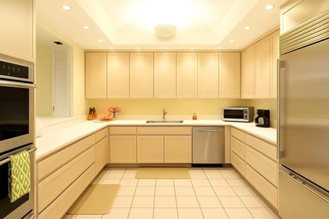 The kitchen features updated stainless steel appliances, complete with a spacious refrigerator, two ovens, a microwave and dishwasher IML-D3