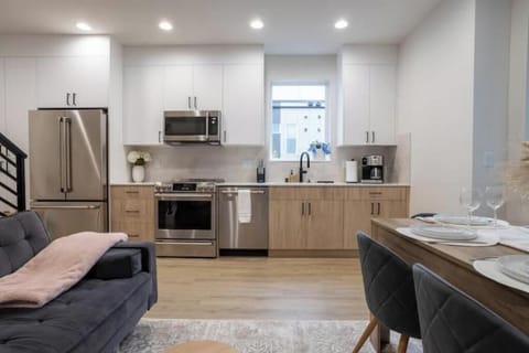 Modern, fully equipped kitchen with premium appliances and CB2 dinnerware.