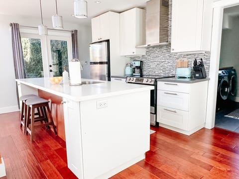 Includes fridge, freezer, stove, dishwasher, coffee maker, kettle and toaster.