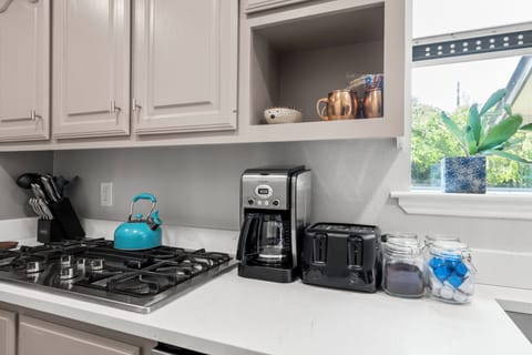 Cuisinart coffee maker with complimentary coffee, tea, sugar, and cream