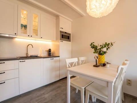 Furniture, Interior Design, Flooring, Countertop, Kitchen, Wood, Kitchen Appliance, Floor, Cabinetry, Room