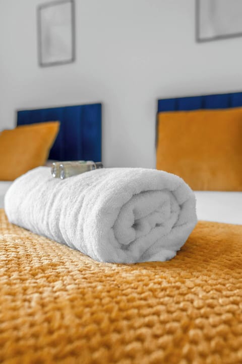 Modern charm with a splash of sunshine, this room offers both restful sleep and uplifting vibes.